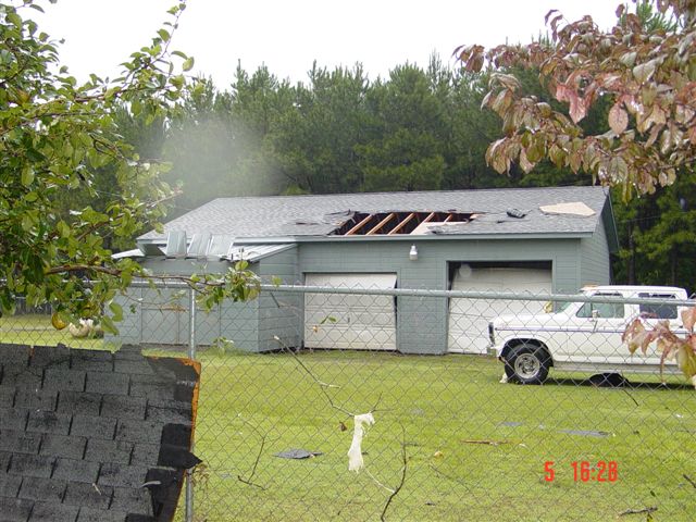 Garage area slightly damaged, part of the roof blown away.